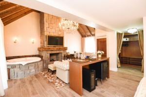 a large living room with a tub and a television at Hotel Cabanas Tio Müller in Gramado