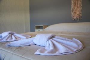 two towels sitting on top of a bed at Aparts ALDEA DEL MONTAÑES in Mina Clavero +19 photos