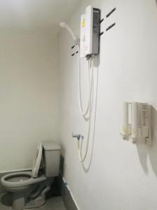 a shower in a bathroom with a toilet at Lanta bluewave Bungkalow in Phra Ae beach