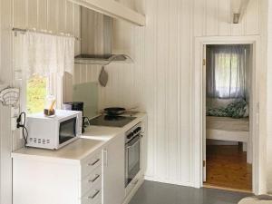 Il comprend une chambre et une petite cuisine équipée d'un four micro-ondes. dans l'établissement Holiday home Mosvik, à Mosvik