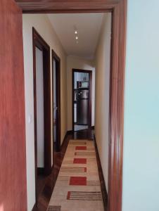 an empty hallway with a kitchen and a refrigerator at Apartamento en Solares in Valdecilla