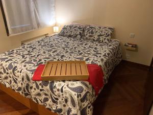 a bedroom with a bed with a bench on it at Apartamento en Solares in Valdecilla