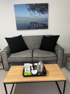 a living room with a couch and a coffee table at Stableford Beach House Plett in Plettenberg Bay