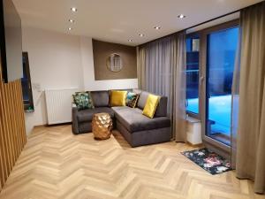 a living room with a couch and a large window at Haus Marion Haueis in Sankt Anton am Arlberg