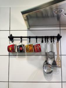 a rack of utensils on a kitchen counter at Pepino, Holiday House with a garden in Vrhnika