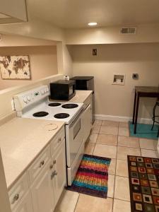 a kitchen with a stove top oven in a room at An English Gem near Union Station in Washington