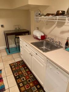 a kitchen with a sink and a counter top at An English Gem near Union Station in Washington +8 photos