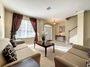 sala de estar con sofá y mesa en This amazing 6 Bedroom property with a lake view villa, en Orlando