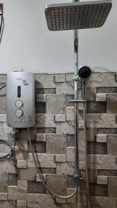 a shower head with a hose attached to a wall at Kingdom of Haven in Ahangama