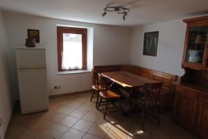 a kitchen with a table and chairs and a window at La Ville CIR00002 in Allein