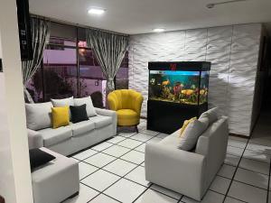 a living room with white couches and a video game at The BRONX HOTEL in Latacunga