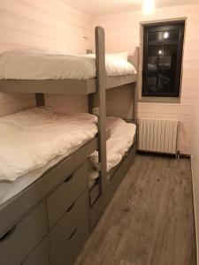 a room with two bunk beds and a window at Grand Sud in Courchevel