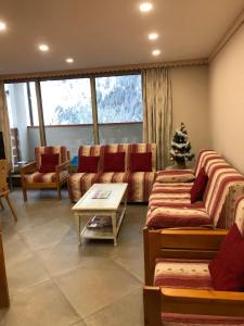 a living room with couches and a christmas tree at Grand Sud in Courchevel