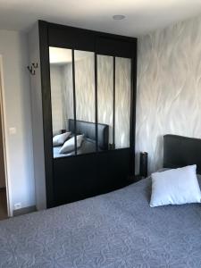 a bedroom with a large mirror and a bed at Grand Sud in Courchevel