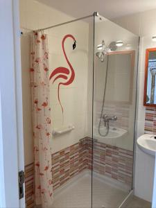 a bathroom with a shower with a snake drawn on the wall at Apartamento Marina in Puerto del Carmen