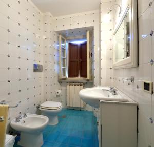 a bathroom with two sinks and a toilet and a mirror at Villa Santa Maria Deruta in Deruta +25 photos