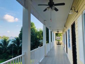 a porch of a house with a ceiling fan at ลิลล์ลดา บูติค โฮเต็ล in Ban Na Oi