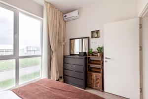 a bedroom with a mirror and a dresser and a window at ixi in Tbilisi City