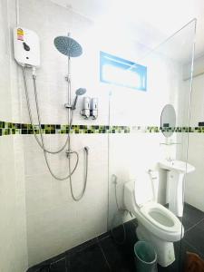 a bathroom with a shower and a toilet at Baan Purada in Ko Lanta