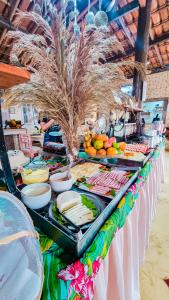 ein Buffet mit Speisen auf einem Tisch am Strand in der Unterkunft Pousada Portal da Concha in Itacaré