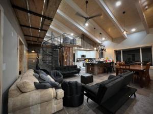 a living room with a couch and chairs and a table at Designer Lake Cabin- HotTub, Sauna & Massage Chair in Ottertail