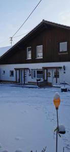 a building with a pole in the snow in front of it at Linda in Ruderatshofen