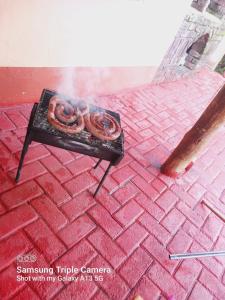 a grill with two pretzels on top at Pythons Guest Lodge in Rustenburg