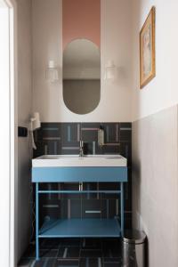 a bathroom with a sink and a mirror at Willa Zalesie in Krynica Zdrój