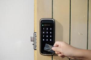a person is unlocking a door with a remote control at 鹿耳宅宅 Lure Guesthouse in Tainan