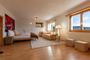 a living room with a bed and a couch at Chalet Casa Acla Laax in Laax