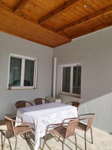 a dining room with a white table and chairs at Zoi Country Home by Eutopia in Ioannina