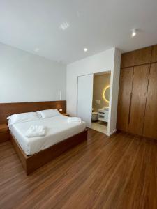 a bedroom with a large bed and a mirror at Villa Grigor in Berat +13 photos