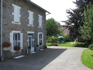 a brick house with a driveway in front of it at L'Ourson in Gérardmer