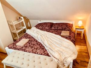 een slaapkamer met een bed met een deken erop bij Romantické chalúpky Raj, Borievka a Čučoriedka in Hrabušice