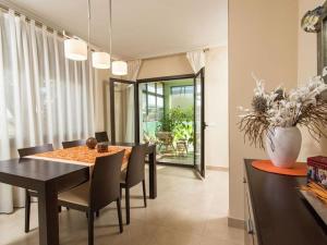 a dining room with a table and chairs and a vase at MAS PALOL in Viladamat