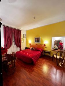 フィレンツェにあるホテル サン ジョルジョ  ＆ オリンピクのベッドルーム1室(赤い大型ベッド1台付)