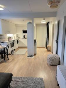 a large living room with a kitchen and a table at Cozy Aparment with sauna nearby Airport in Vantaa