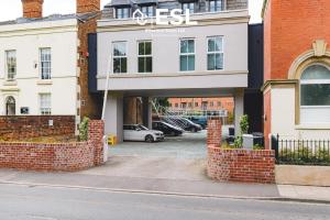 a building with a parking lot in front of it at High Quality 2 Bedroom Church Apartment with Free Parking in Shrewsbury