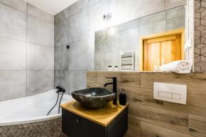 łazienka z umywalką i wanną w obiekcie Apartament Sova w mieście Kościelisko +18 zdjęć