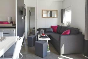 a living room with a couch and a table at Kanopée Village in Trévoux