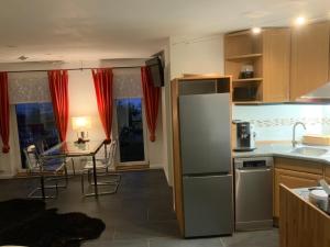 a kitchen with a stainless steel refrigerator and a table at Kaeppler-Hof-Wieners in Olsberg