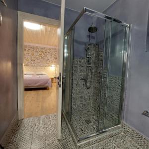 a glass shower in a room with a bedroom at Neon in Larisa