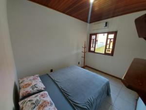 En eller flere senger på et rom på Casa Barra da Ibiraquera