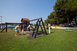 a group of people playing in a park at Apartments Galijot Plava Laguna in Poreč