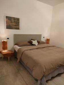 a bedroom with a large bed and a chair at ,,,a casa di Martina in Mestre