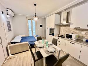 kuchnia oraz salon ze stołem i łóżkiem w obiekcie [Metro-apartment]: fabolous flat w mieście Moncalieri