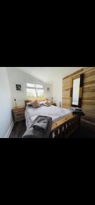 a bedroom with a large bed and a mirror at The stables 