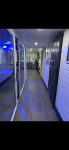 an empty hallway of a house with a door and a room at The stables 