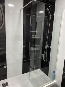 a bathroom with a glass shower with a toilet at Lotus house in Zrenjanin +28 photos