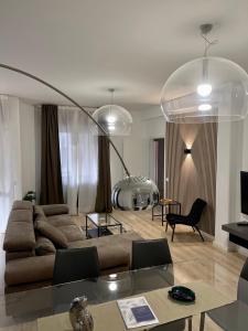 a living room with a couch and a table at Aci Boutique Apartment in Acitrezza